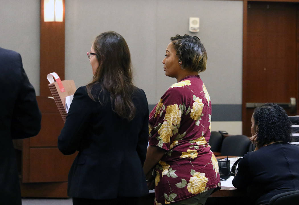Cadesha Bishop, 25, right, accused of shoving a 74-year-old man off a bus, appears in court wit ...