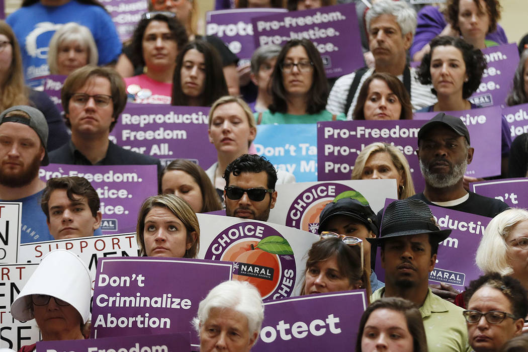 Abortion rights supporters stand during a news conference by Presidential candidate Sen. Kirste ...