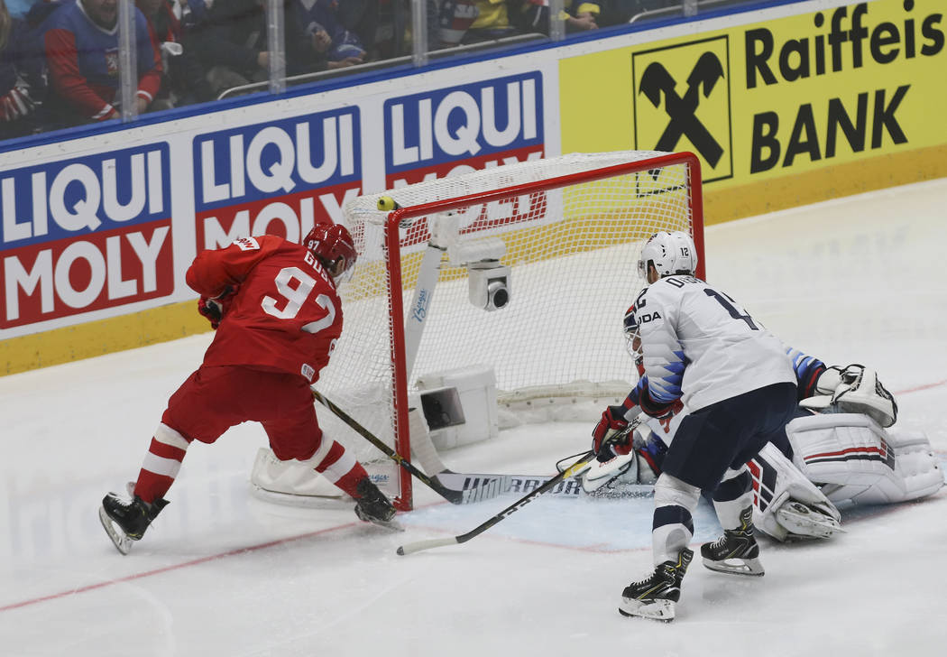Russia's Nikita Gusev, left, scores his side's first goal during the Ice Hockey World Champions ...