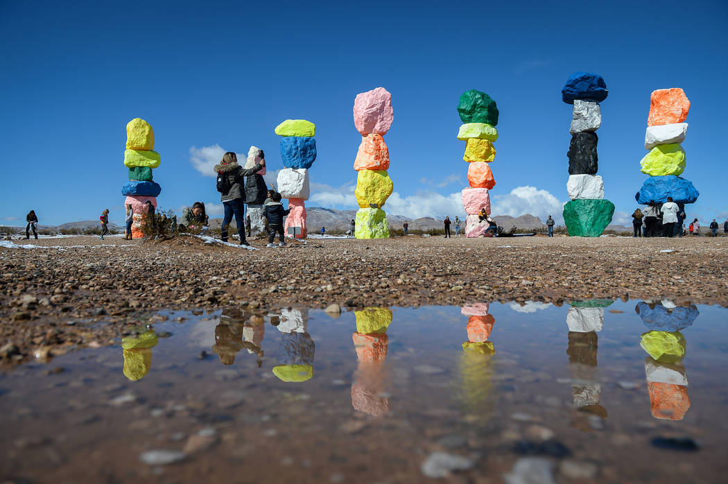 Tourists visit the Seven Magic Mountains in Clark County, Monday, Feb. 18, 2019. (Caroline Breh ...