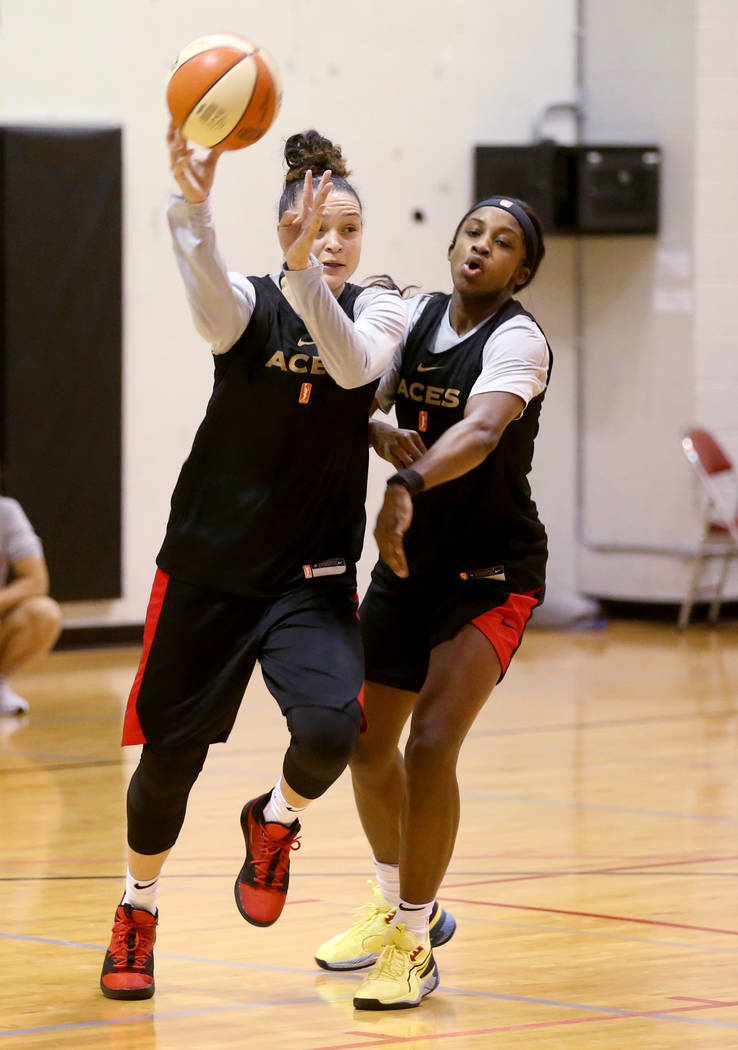 Las Vegas Aces guard Kayla McBride (21) passes around Jackie Young during practice at Cox Pavil ...