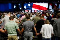 FILE - In this June 12, 2018 file photo, people pray for America at the 2018 annual meeting of ...