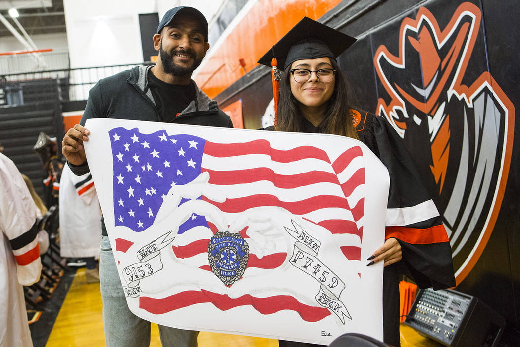 Cici's Pizza franchise owner Bill Badruddin, left, poses with Cassandra Sosa as they hold up he ...