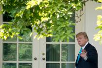President Donald Trump waves as he walks towards the Oval Office in Washington, Thursday, May 2 ...