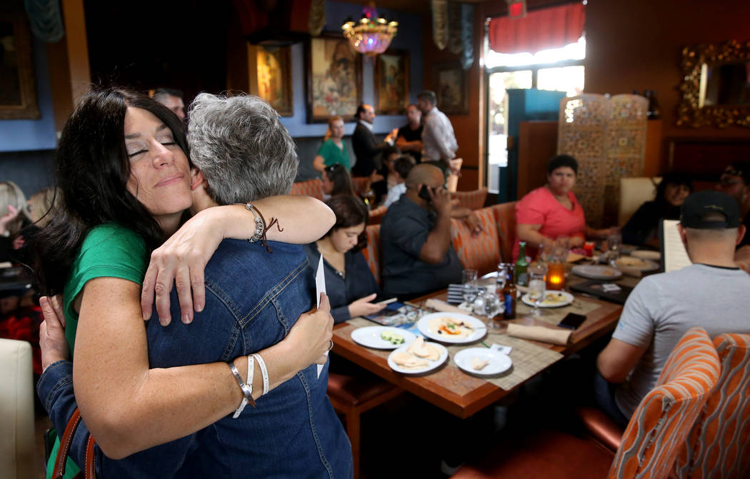 Courtney Kaplan, left, mother of Michael "Mikie" Sigler, the Cimarron-Memorial High S ...