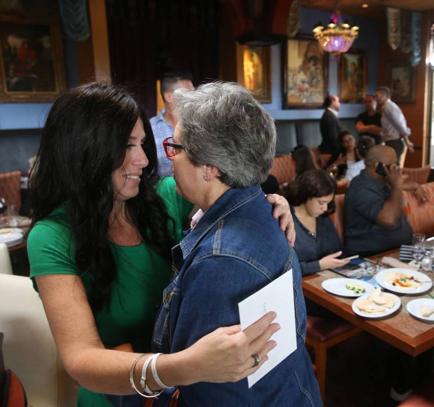 Courtney Kaplan, left, mother of Michael "Mikie" Sigler, the Cimarron-Memorial High S ...