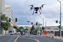 In a May 21, 2019 photo, two drones fly above Lake Street in downtown Reno, Nev., on, as part o ...