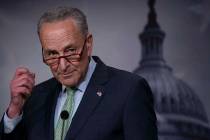 Senate Minority Leader Chuck Schumer, D-N.Y., talks to reporters just after the Senate passed a ...