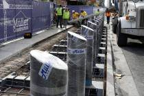 Construction crews pour cement as they began installing steel bollards on the Strip near Aria h ...