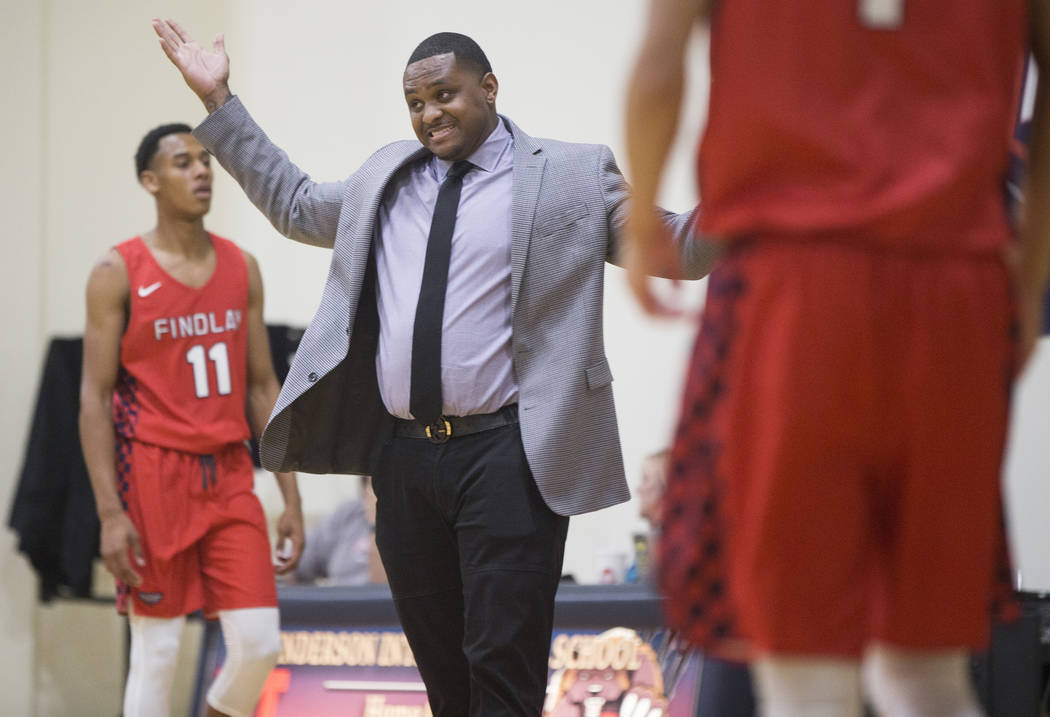 Findlay Prep head coach Rodney Haddix, middle, contests a call during the Pilot's home matchup ...