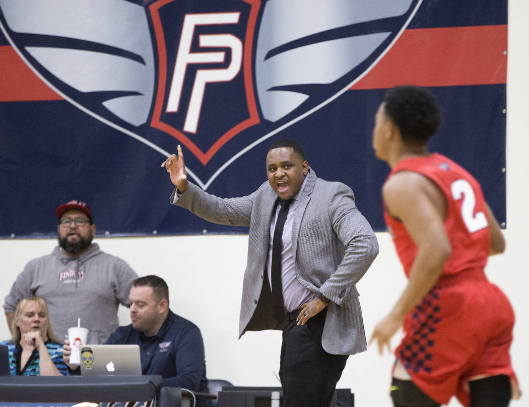 Findlay Prep head coach Rodney Haddix, middle, makes a call during the Pilot's home matchup wit ...