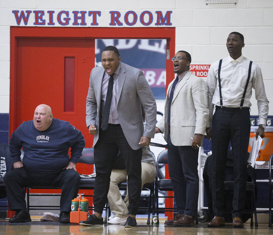 Findlay Prep head coach Rodney Haddix, second from left, reacts to a call during the Pilot's ho ...