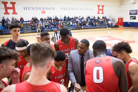 Findlay Prep head coach Rodney Haddix, right, draws up a play during a timeout during the Pilot ...