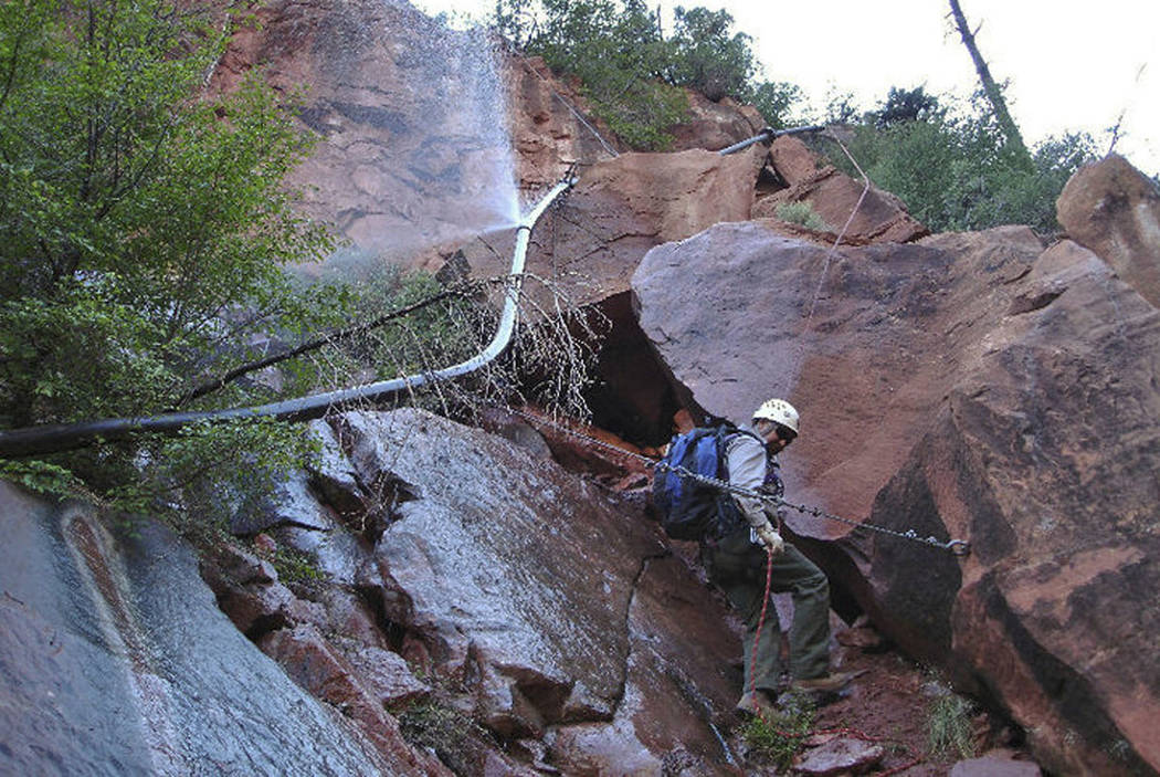 A water sprays from a break in an exposed section of the Grand Canyon trans-canyon waterline as ...