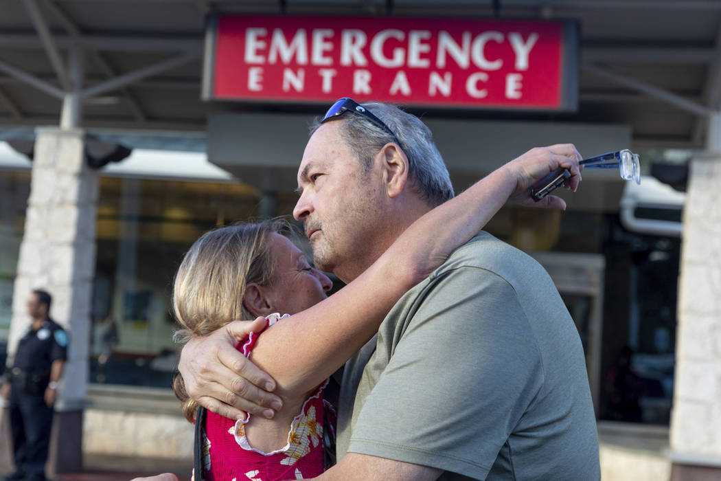 Sarah Haynes, left, embraces John Eller, father of Amanda Eller, outside the Maui Memorial Hosp ...