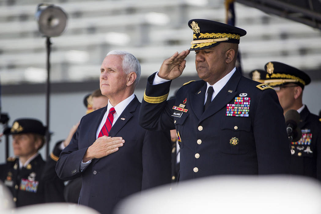 Vice President Mike Pence stands for the national anthem during graduation ceremonies at the Un ...