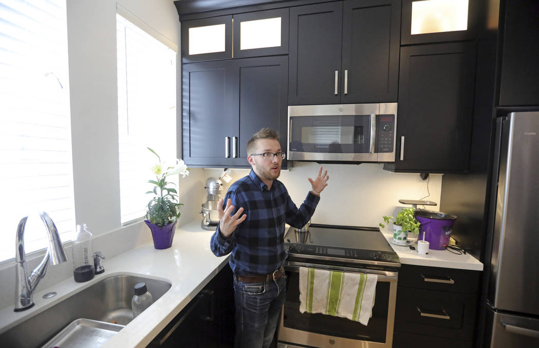 Parry Harrison, 26, speaks during an interview in his townhouse in the Daybreak development, in ...