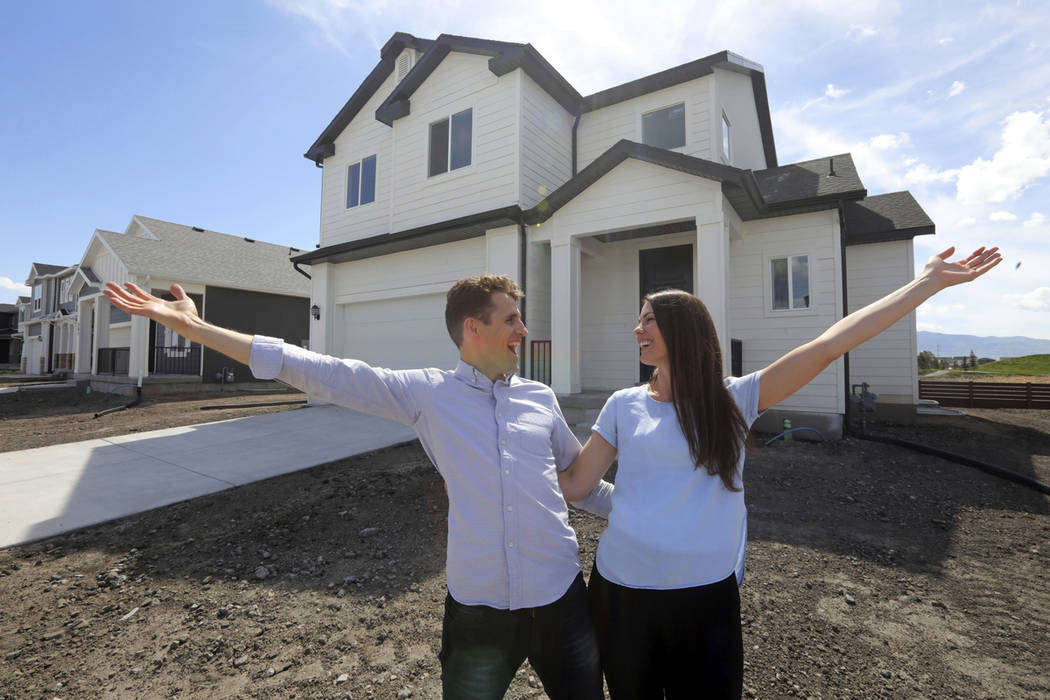 Andy and Stacie Proctor stand in front of their new home in Vineyard, Utah, in April 2019. (AP ...