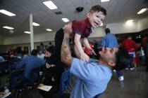 Inmate Anthony Caubet, 22, lifts his son Alexander, 2, following his graduation from the Youthf ...