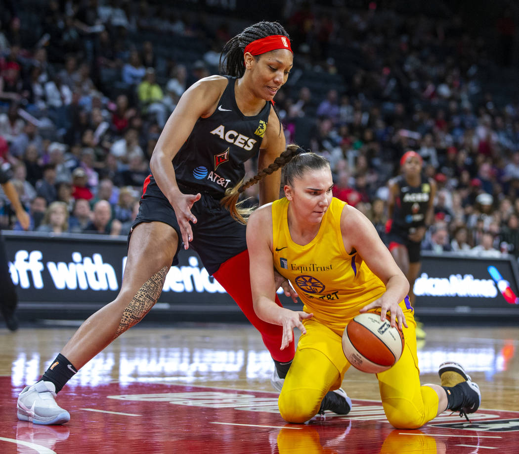 Las Vegas Aces center A'ja Wilson (22) looks down to the ball scooped up by Los Angeles Sparks ...