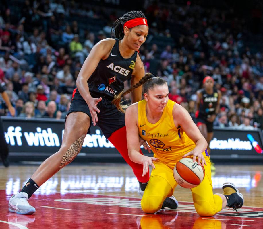 Las Vegas Aces center A'ja Wilson (22) looks down to the ball scooped up by Los Angeles Sparks ...