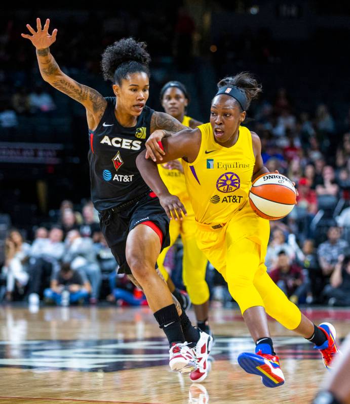 Las Vegas Aces forward Tamera Young (1) defends the lane from Los Angeles Sparks guard Chelsea ...