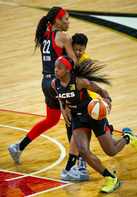 Las Vegas Aces guard Jackie Young (0) drives t6he lane past a pick by teammate center A'ja Wils ...