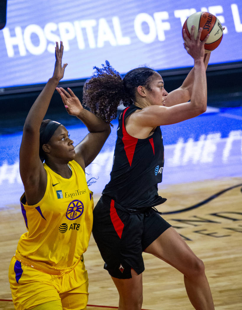 Los Angeles Sparks center Kalani Brown (21) defends the basket from Las Vegas Aces forward Dear ...