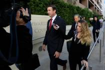 FILE - In this Dec. 3, 2018 file photo Republican Rep. Duncan Hunter, center, leaves court in S ...