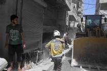 This photo provided by the Syrian Civil Defense White Helmets, which has been authenticated bas ...