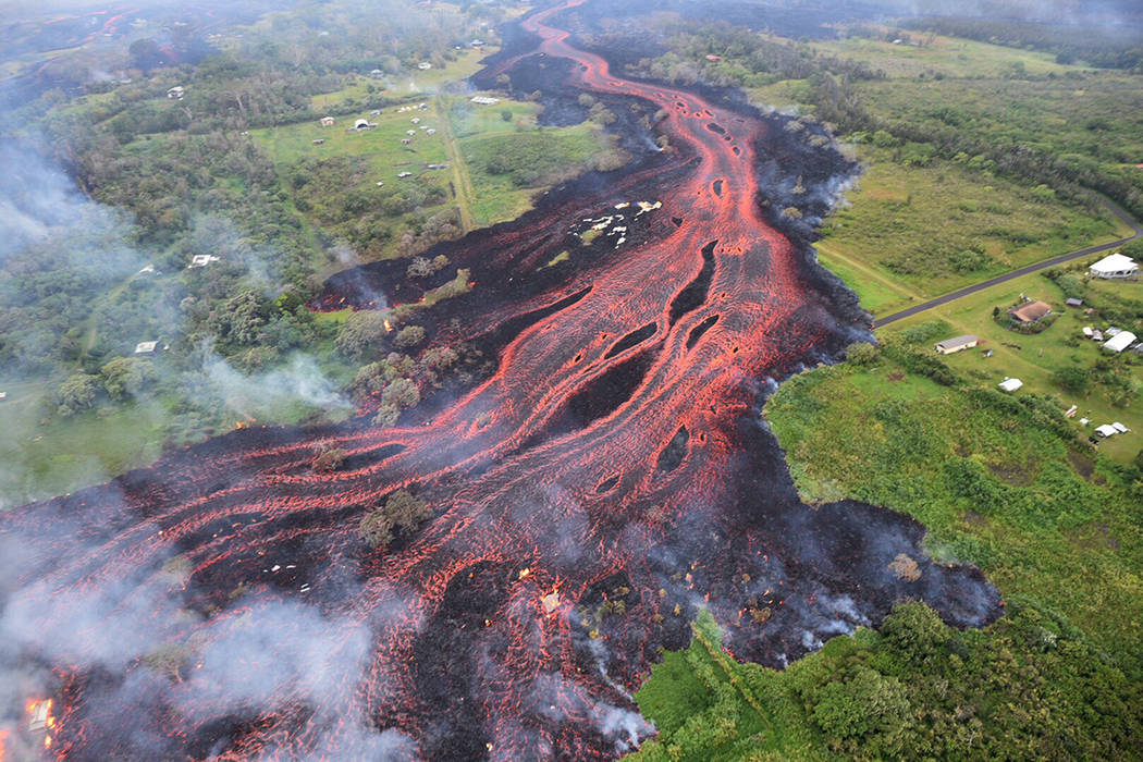 In this Saturday, May 19, 2018, photo released by the U.S. Geological Survey, lava flows from f ...