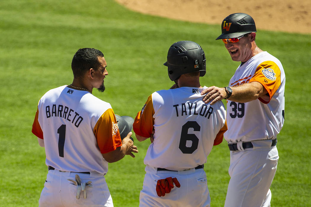 (From right) Aviators manager Fran Riordan (39) shares a laugh with base runners Beau Taylor (6 ...