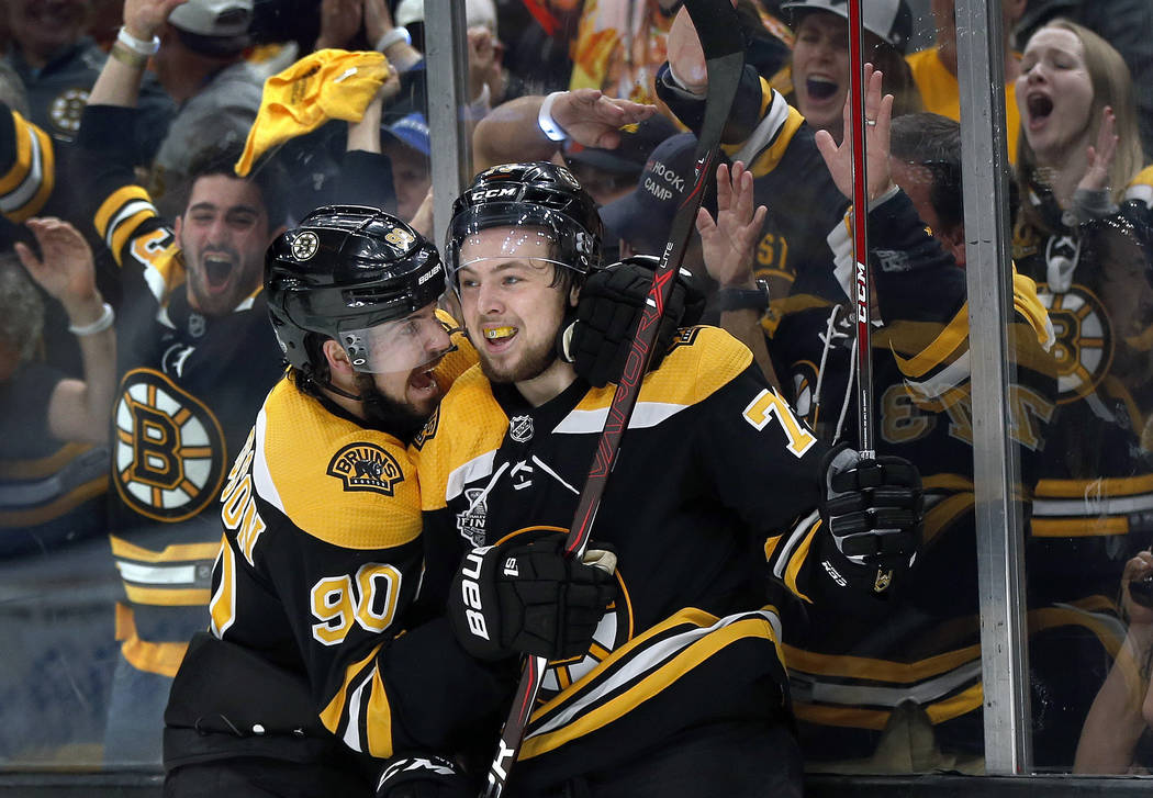 Boston Bruins' Charlie McAvoy, right, celebrates his goal against the St. Louis Blues with Marc ...