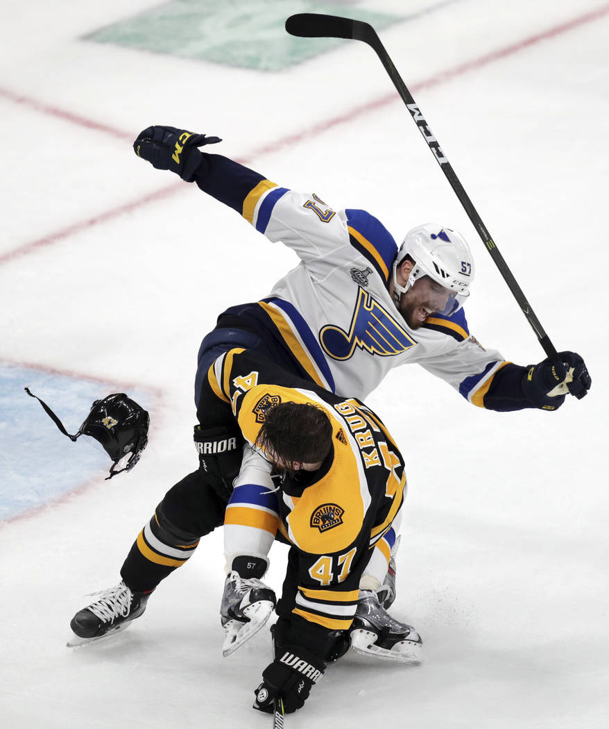 St. Louis Blues' David Perron (57) rips the helmet off Boston Bruins' Torey Krug (47) during th ...