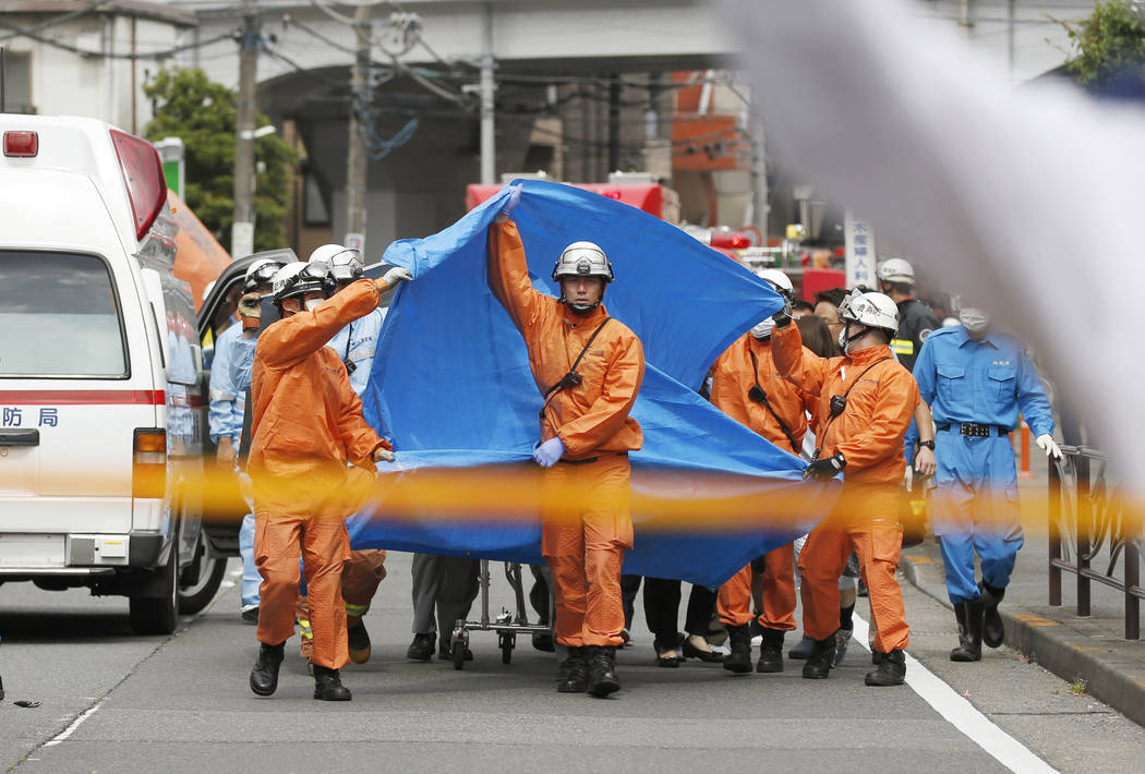 Rescuers work at the scene of an attack in Kawasaki, near Tokyo Tuesday, May 28, 2019. A man wi ...