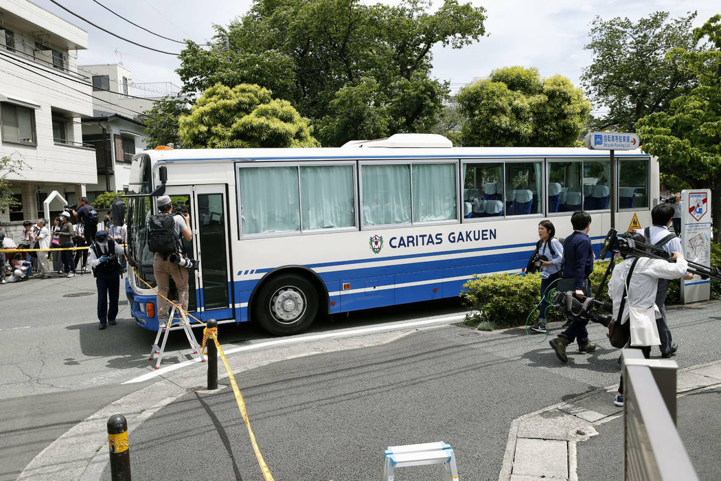 CARITAS Elementary School bus is seen near the scene where a man wielding a knife attacked comm ...
