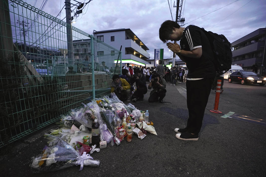 A man pays respects at a makeshift memorial for the victims of a knife attack Tuesday, May 28, ...