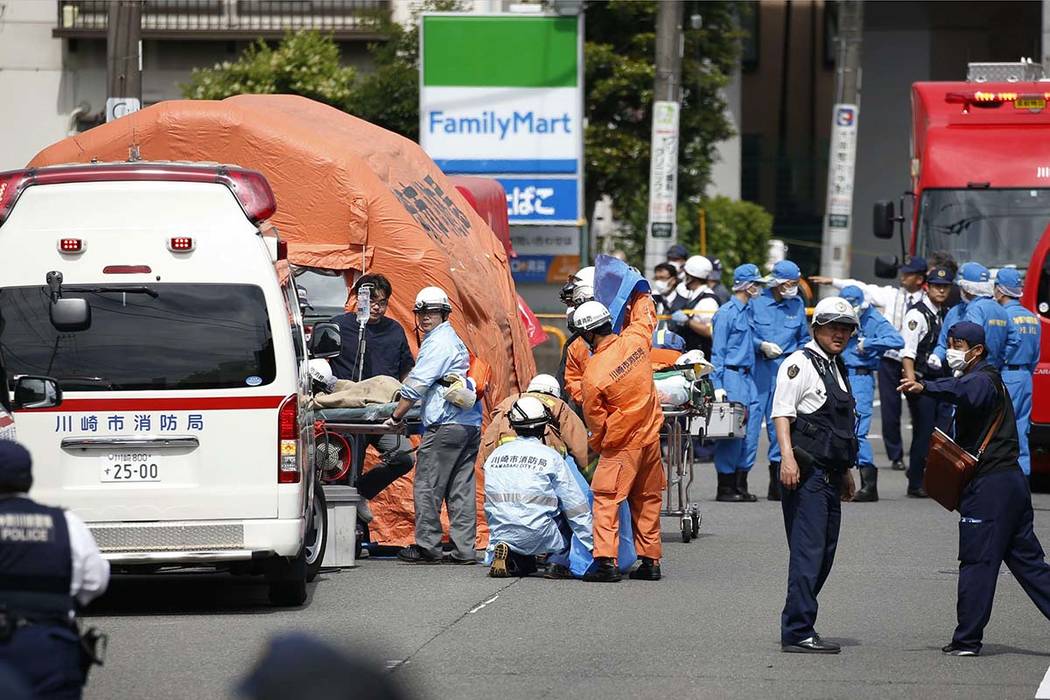 Rescuers work at the scene of an attack in Kawasaki, near Tokyo Tuesday, May 28, 2019. A man wi ...