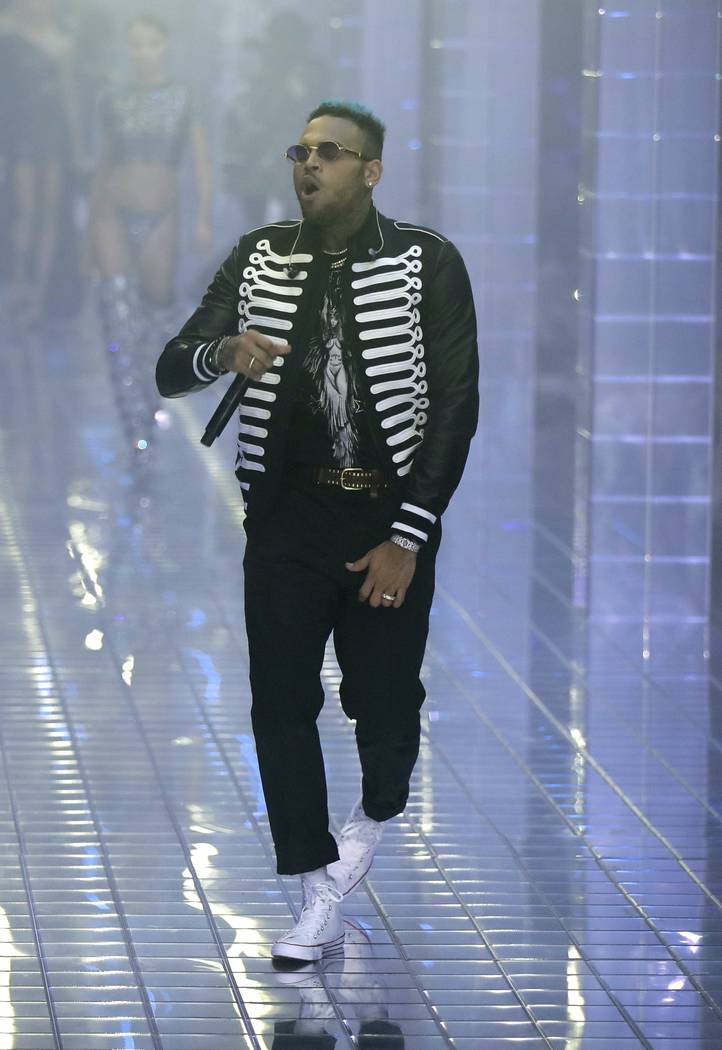 FILE - In this Sept. 21, 2018 file photo, US rapper Chris Brown performs during Philipp Plein's ...