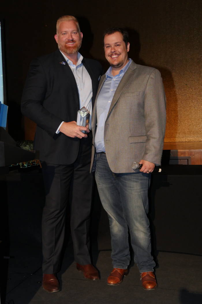 YPN Chair Andrew Dionne, left, and Vice Chair Geoffrey Zahler, right, enjoy the May 23 YPN Top ...