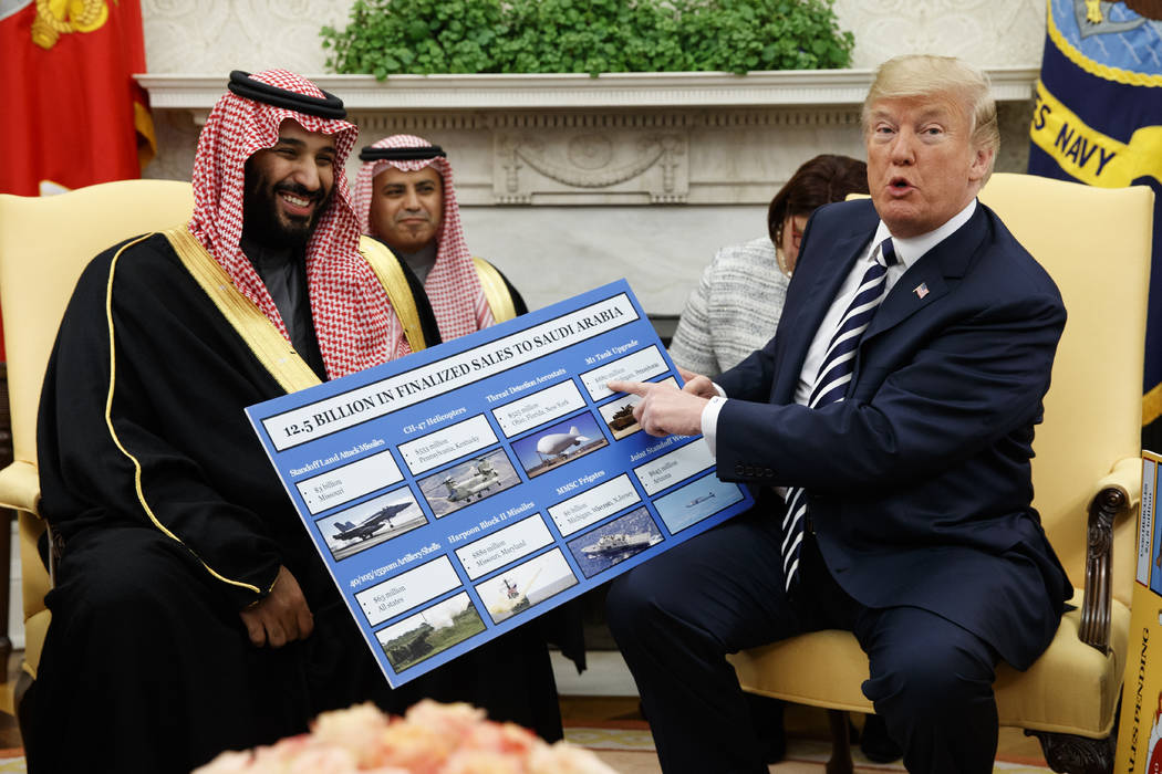 FILE - In this March 20, 2018 file photo, President Donald Trump shows a chart highlighting arm ...
