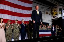 President Donald Trump arrives on stage to speak to troops at a Memorial Day event aboard the U ...