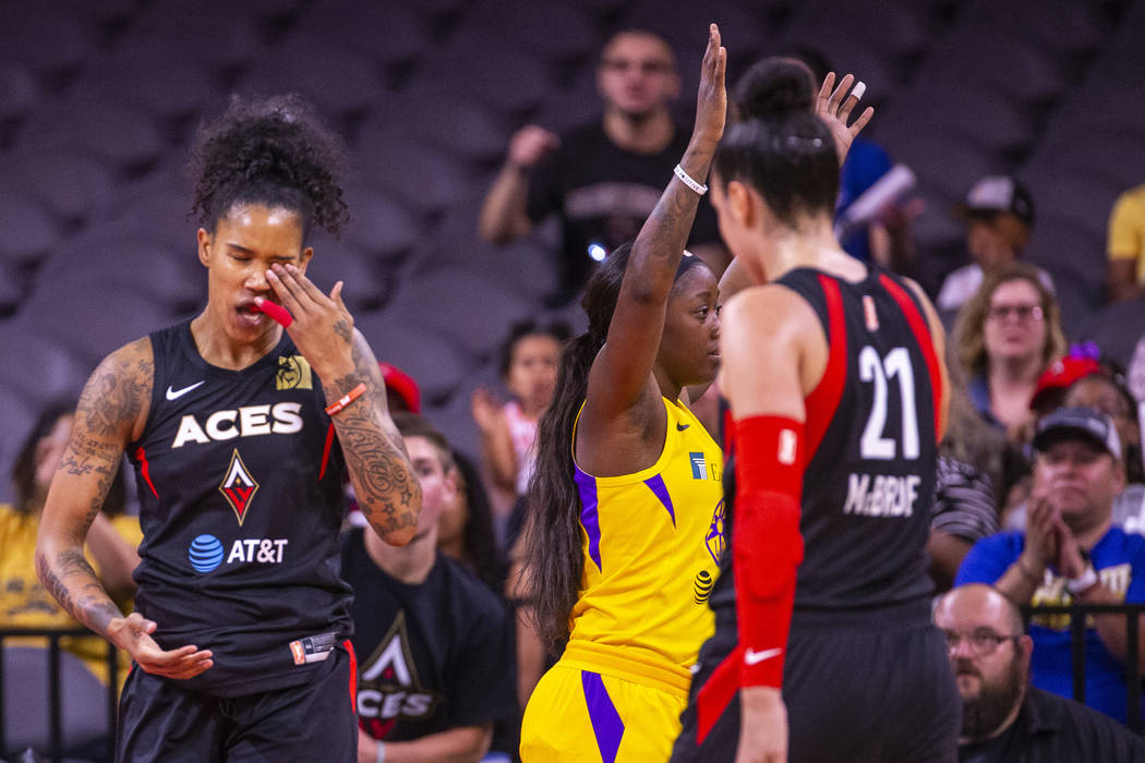 Las Vegas Aces forward Tamera Young (1) reacts to a poke in the eye from Los Angeles Sparks gua ...