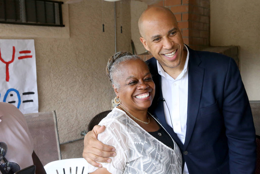 Presidential hopeful Sen. Cory Booker, D-N.J., poses with Pat Stevens of Las Vegas at a Miracle ...