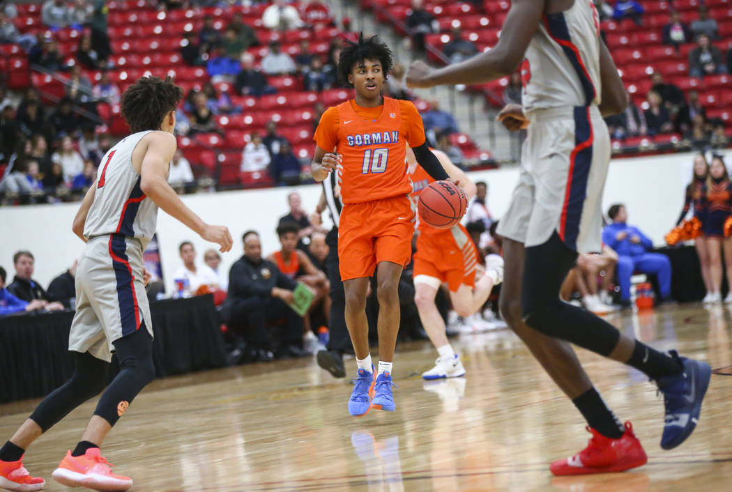 Bishop Gorman's Zaon Collins (10) brings the ball up court during the first half of the annual ...