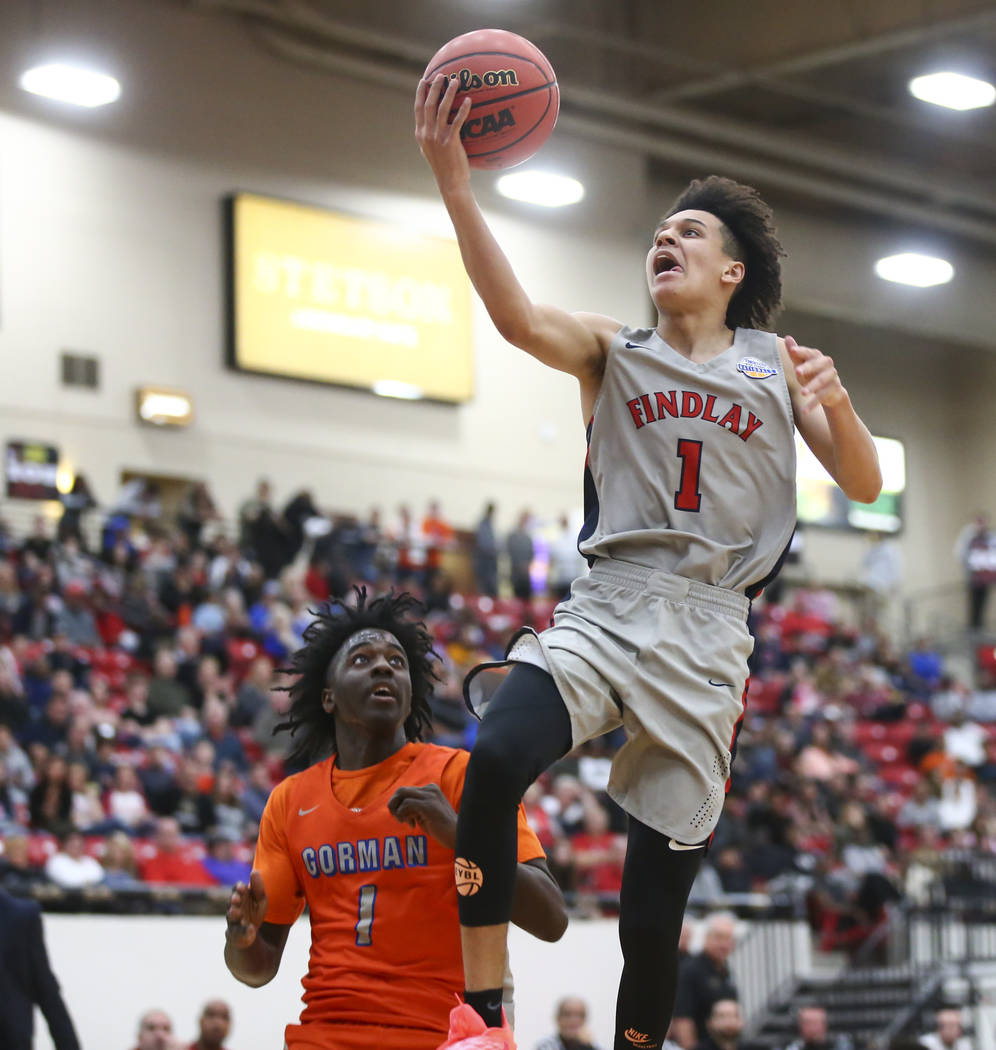 Findlay Prep's Blaise Beauchamp (1) goes to the basket over Bishop Gorman's Will McClendon (1) ...