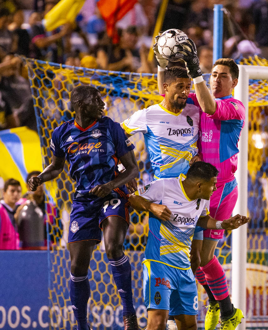 (From right) Las Vegas Lights FC goalkeeper Thomas Olsen (1) grabs a kicked ball above the head ...