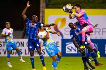 (From right) Las Vegas Lights FC goalkeeper Thomas Olsen (1) grabs a shot on goal over Tulsa Ro ...