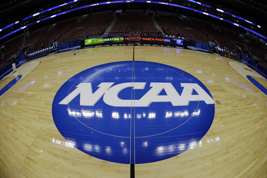 In this March 21, 2013, file photo, taken with a fisheye lens, the NCAA logo is displayed on th ...