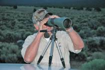 Gary Pratt, of Las Vegas, uses a spotting scope to get a close-up view of a Nevada mule deer. W ...
